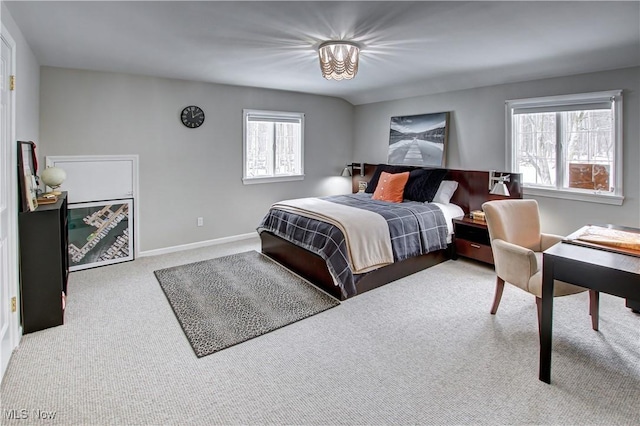 bedroom with light carpet, multiple windows, and baseboards