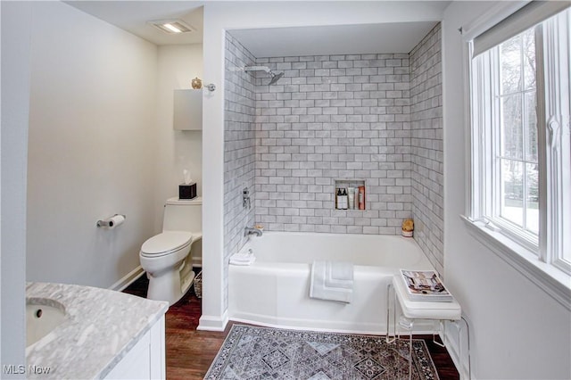 full bathroom with baseboards, bathing tub / shower combination, toilet, wood finished floors, and vanity