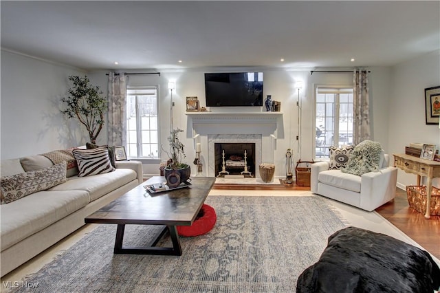 living room featuring ornamental molding, a fireplace, wood finished floors, and recessed lighting