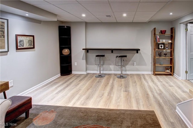 home office with light wood-type flooring, baseboards, a drop ceiling, and recessed lighting