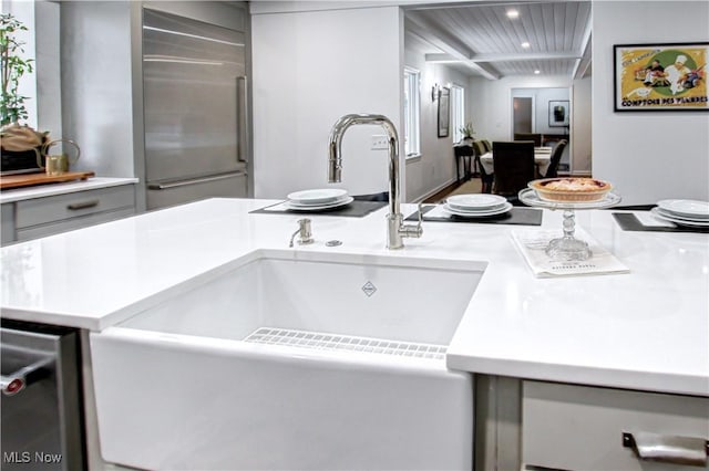 interior details with recessed lighting, gray cabinets, light countertops, and built in fridge