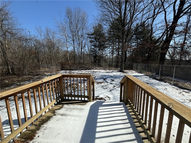 snow covered deck with fence