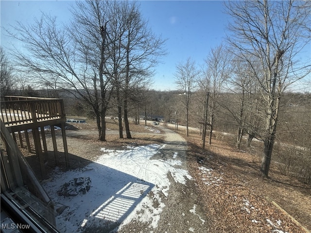 yard covered in snow with a wooden deck