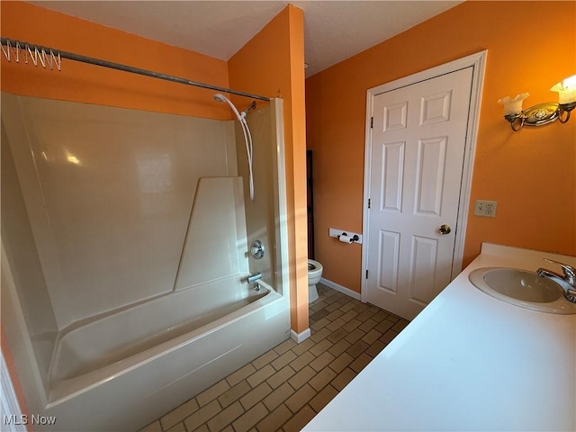 full bathroom featuring baseboards, toilet, brick floor, shower / bathtub combination, and a sink