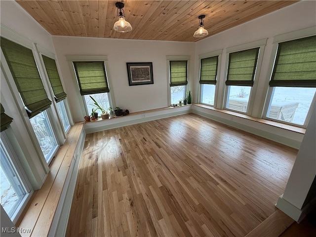 empty room with wood ceiling and light wood-style floors