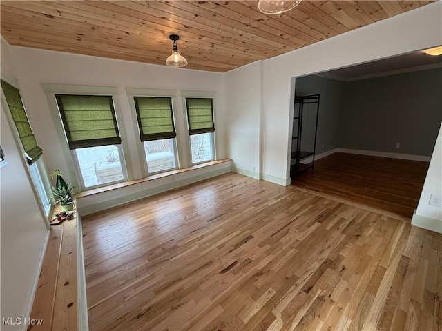 unfurnished room with wooden ceiling, baseboards, and light wood finished floors