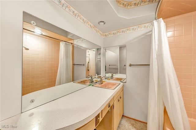 full bath with a shower with curtain, baseboards, and vanity