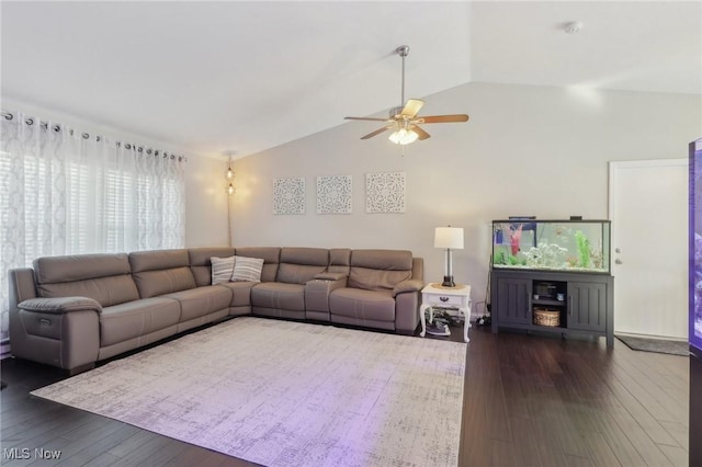 living area with vaulted ceiling, dark wood-type flooring, and a ceiling fan