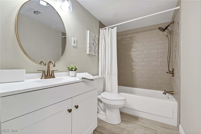 full bathroom featuring visible vents, vanity, toilet, and shower / bath combo with shower curtain