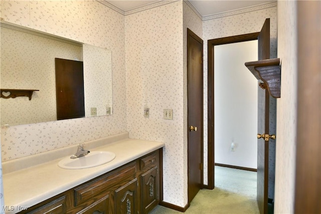 bathroom with wallpapered walls, baseboards, and vanity