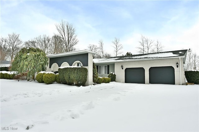 view of front of home with brick siding and an attached garage