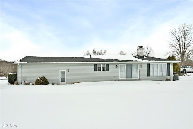 view of snow covered back of property