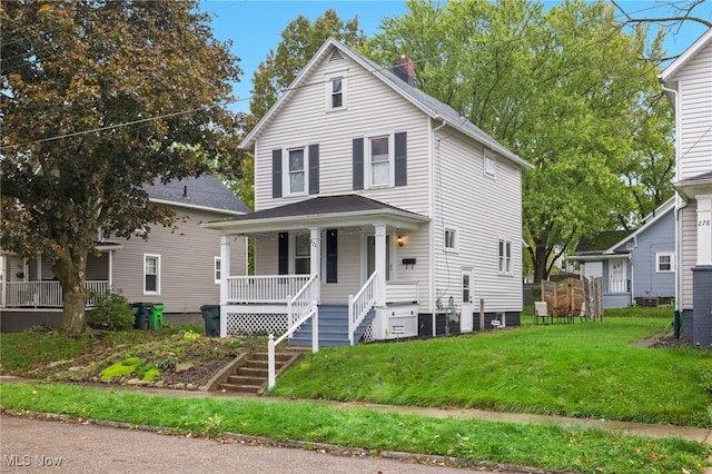 view of front of property with covered porch, a front yard, and stairs