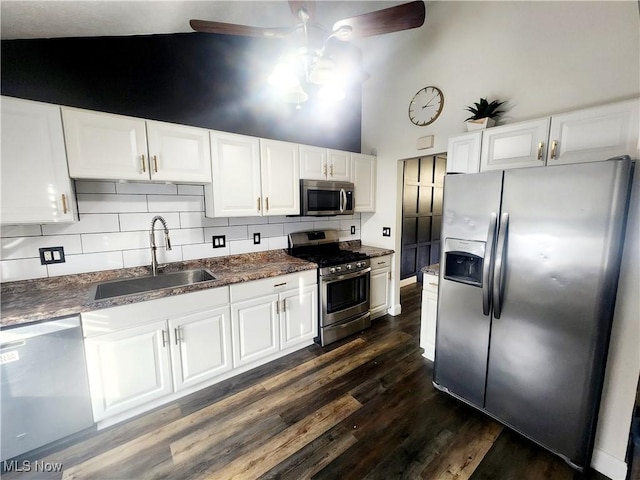 kitchen featuring appliances with stainless steel finishes, dark wood-type flooring, white cabinetry, a sink, and ceiling fan