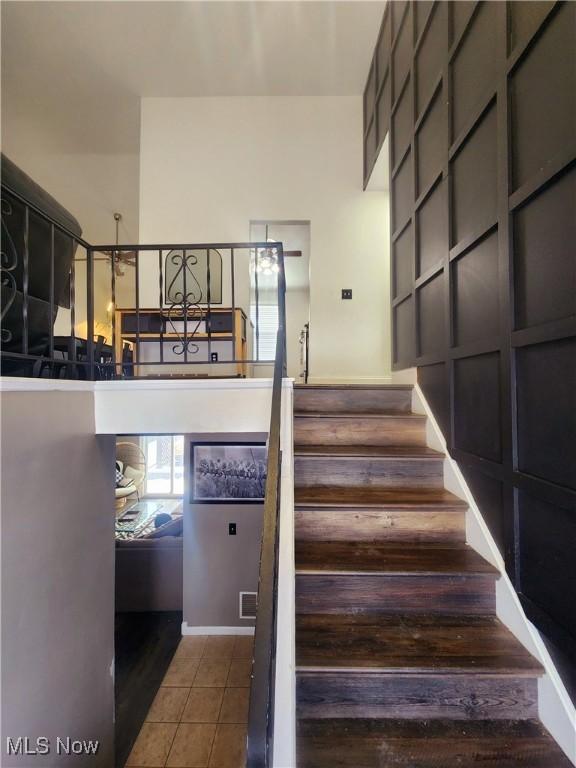 stairs with visible vents and tile patterned floors