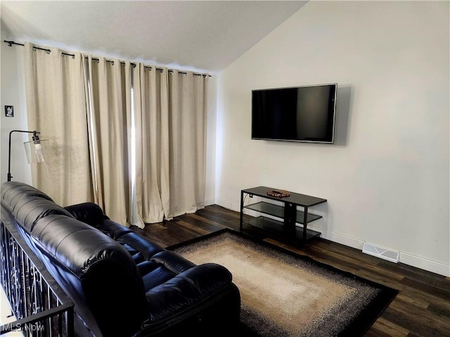 living room featuring dark wood-style floors, lofted ceiling, visible vents, and baseboards