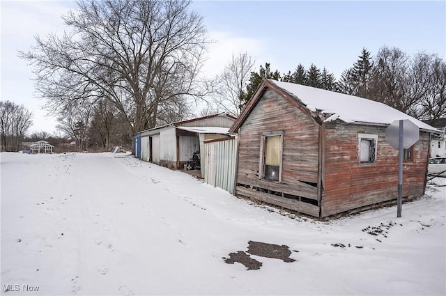 view of snowy exterior featuring a garage