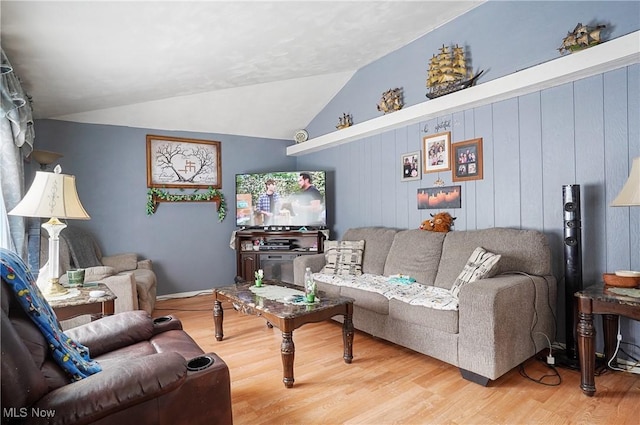 living room featuring lofted ceiling and wood finished floors