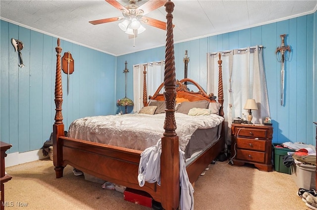 carpeted bedroom with ceiling fan and crown molding