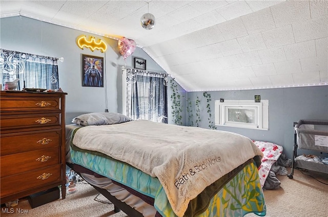 bedroom with lofted ceiling, light colored carpet, and a textured ceiling