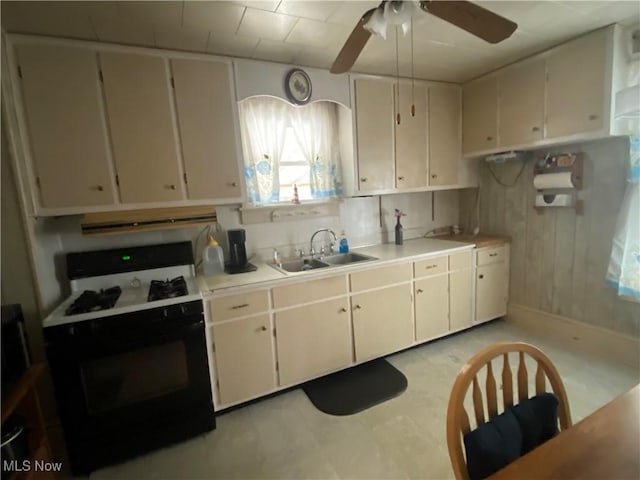 kitchen with white cabinets, light countertops, and gas range oven