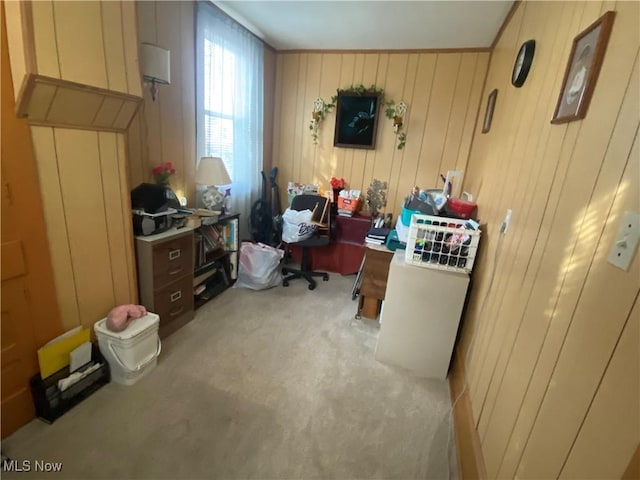 office area with light carpet and wood walls