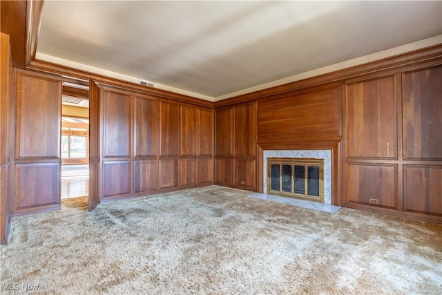 unfurnished living room featuring visible vents, carpet, and a high end fireplace