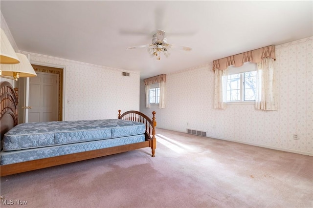 bedroom featuring baseboards, carpet flooring, visible vents, and wallpapered walls