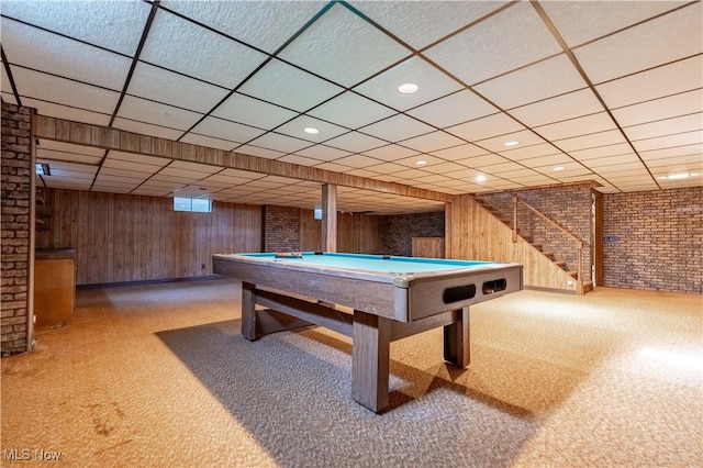 recreation room featuring carpet flooring, wood walls, brick wall, and billiards