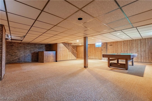 basement featuring carpet, wooden walls, and pool table