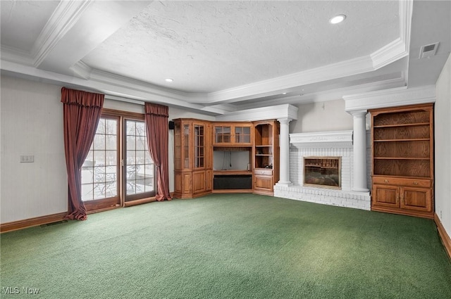 unfurnished living room with visible vents, a raised ceiling, carpet, crown molding, and a brick fireplace