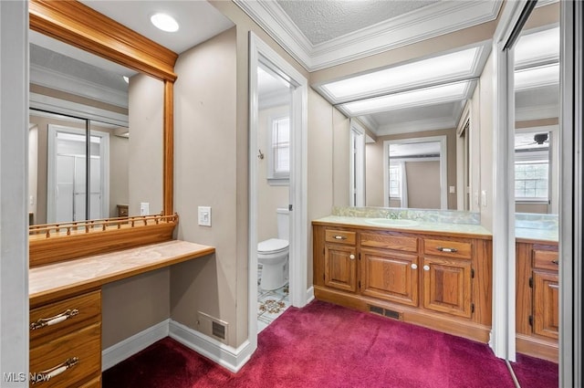 bathroom with ornamental molding, visible vents, vanity, and toilet