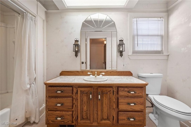 bathroom featuring shower / bath combination with curtain, vanity, toilet, and wallpapered walls