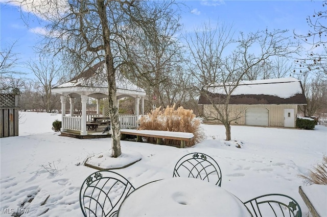 yard covered in snow featuring a gazebo