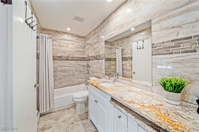 bathroom featuring toilet, shower / tub combo, visible vents, and vanity