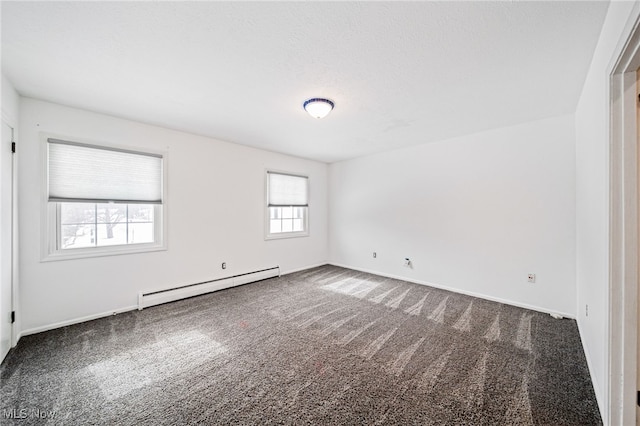 carpeted spare room featuring a baseboard radiator and baseboards