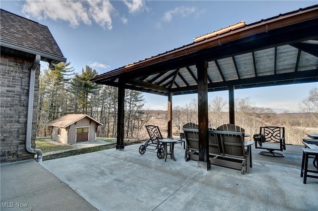 view of patio / terrace featuring a gazebo, an outbuilding, and a storage shed