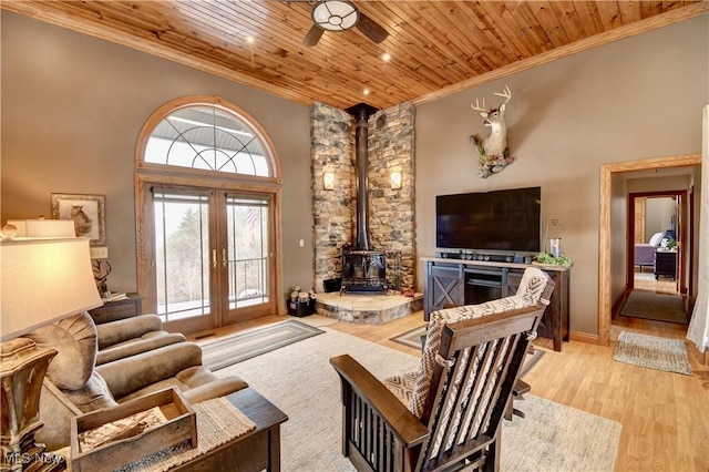 living room featuring ornamental molding, french doors, light wood finished floors, and wooden ceiling