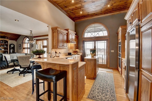 kitchen featuring appliances with stainless steel finishes, wood ceiling, open floor plan, and light countertops