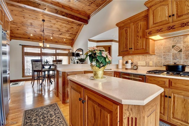 kitchen featuring pendant lighting, light countertops, decorative backsplash, a kitchen island, and wooden ceiling