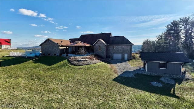 view of front facade with a garage, driveway, and a front yard