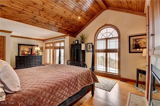 bedroom featuring a fireplace, crown molding, vaulted ceiling, light wood-type flooring, and wooden ceiling