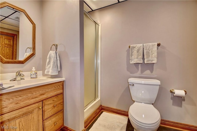 bathroom featuring bath / shower combo with glass door, vanity, toilet, and baseboards