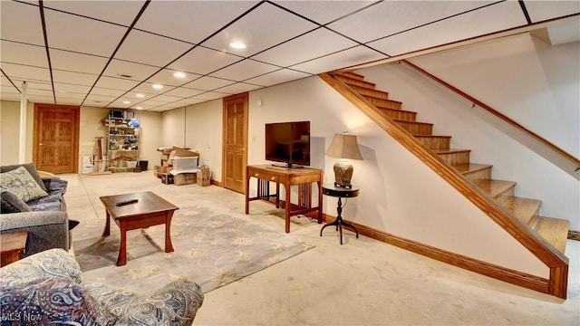 living room with light carpet, a drop ceiling, and stairway