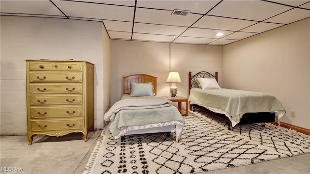 bedroom with visible vents and concrete block wall