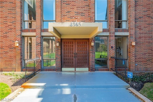 doorway to property featuring brick siding