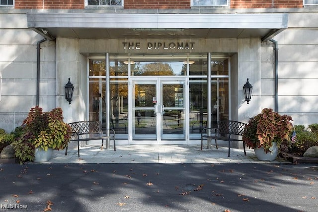 view of exterior entry featuring brick siding