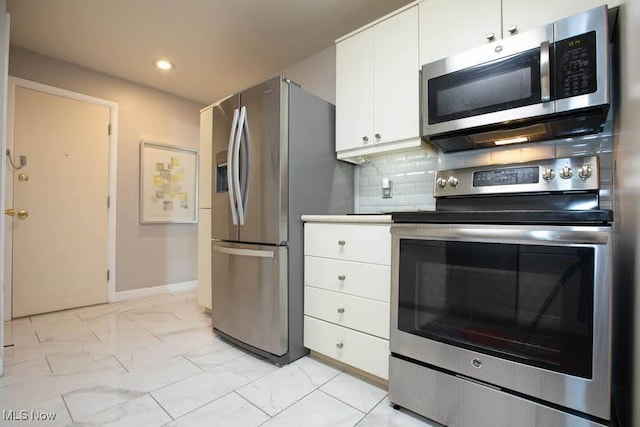 kitchen featuring white cabinets, decorative backsplash, marble finish floor, stainless steel appliances, and light countertops