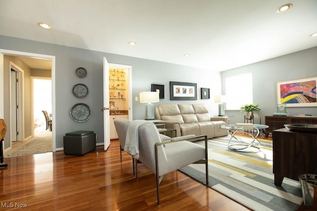 living area with wood finished floors and recessed lighting