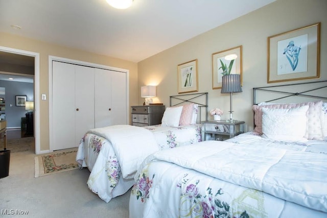 bedroom featuring light carpet and a closet